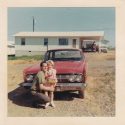 Dad and daughter in the 1960s in front of red Comet