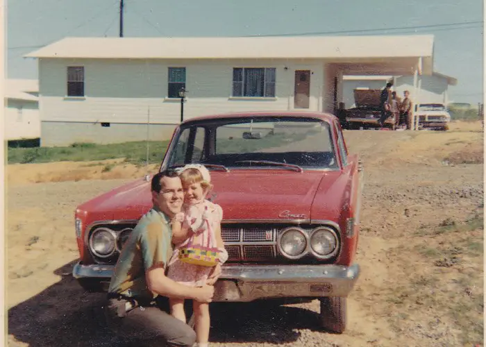 Dad and daughter in the 1960s in front of red Comet