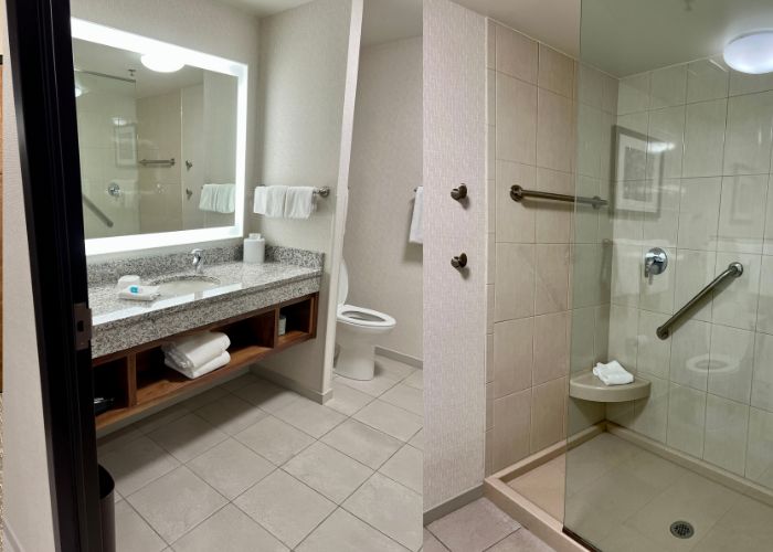 Spacious, pristine bathroom with a glass-enclosed shower at Drury Inn.