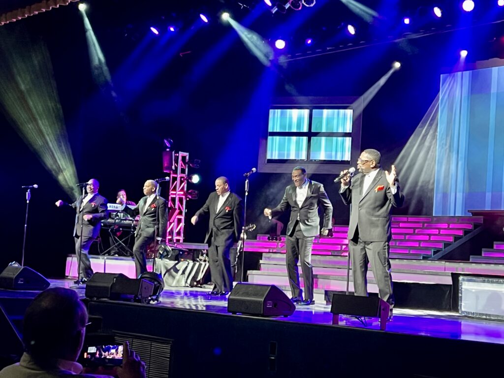 The Temptations singing on stage.