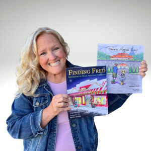 Childrens book author holding two books